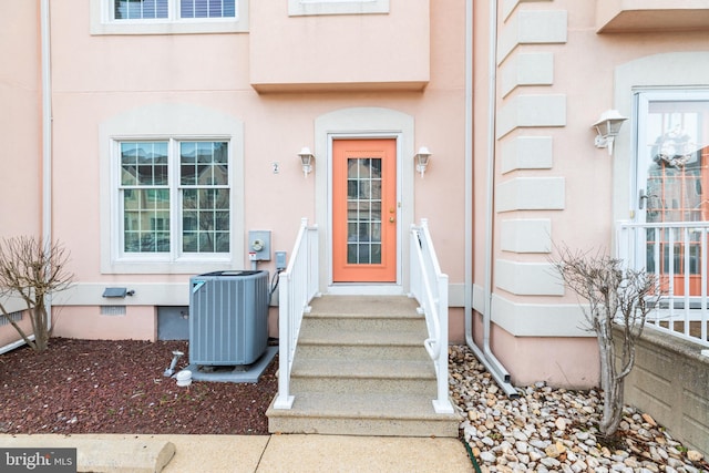 entrance to property featuring cooling unit