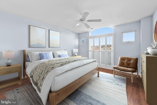 bedroom with dark hardwood / wood-style floors and ceiling fan