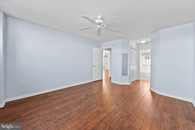 empty room with dark hardwood / wood-style floors and ceiling fan