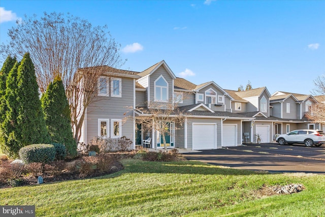 multi unit property featuring a garage and a front yard