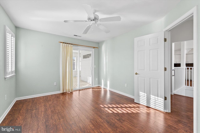 empty room with ceiling fan and dark wood-type flooring