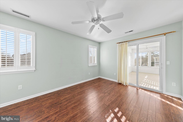 empty room featuring dark hardwood / wood-style flooring and ceiling fan