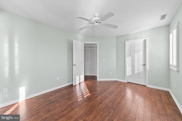 unfurnished bedroom with ceiling fan and dark hardwood / wood-style floors