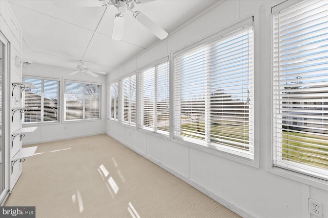 unfurnished sunroom with a wealth of natural light and ceiling fan