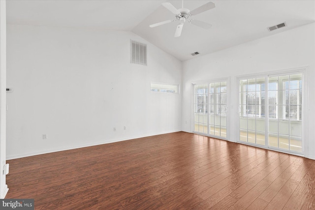 spare room with dark hardwood / wood-style floors, vaulted ceiling, and ceiling fan