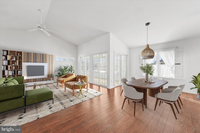 dining area featuring light wood-type flooring, vaulted ceiling, and ceiling fan