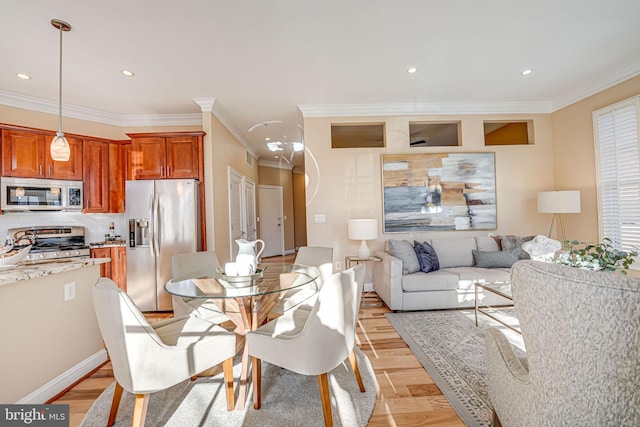 dining area with light hardwood / wood-style floors and ornamental molding