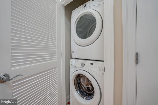 laundry area featuring stacked washer / drying machine