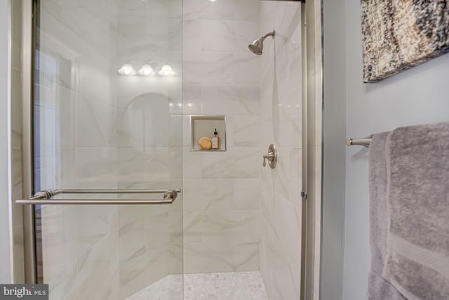 bathroom featuring a shower with door