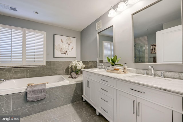 bathroom with plus walk in shower and vanity