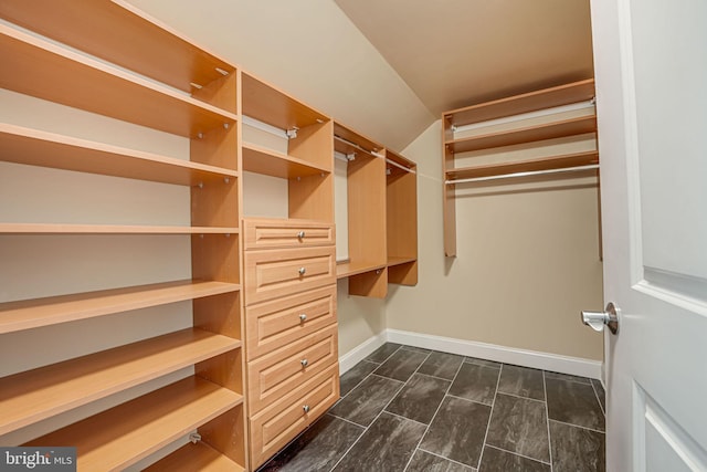 walk in closet with lofted ceiling