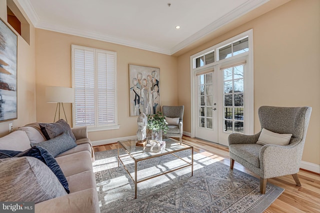 living room featuring light hardwood / wood-style flooring and ornamental molding