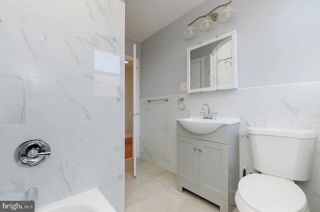 full bathroom featuring toilet, tile walls, and vanity