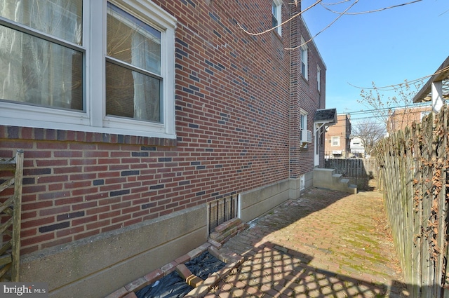 view of property exterior with brick siding