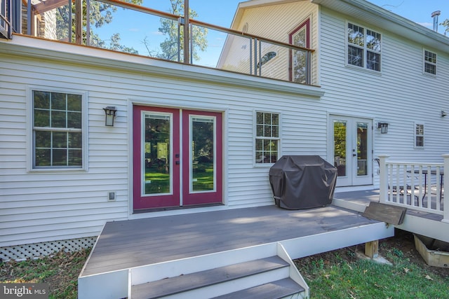 rear view of house with a wooden deck and french doors