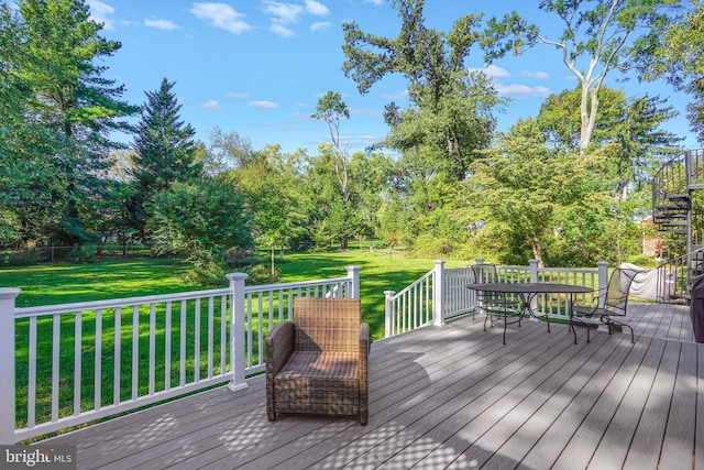 wooden deck featuring a yard