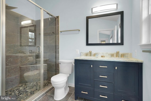 bathroom with tile patterned flooring, vanity, toilet, and a shower with door