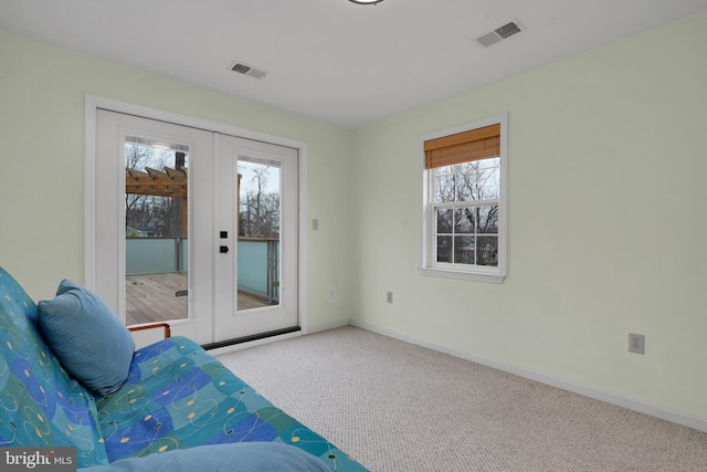 unfurnished room featuring light colored carpet and french doors