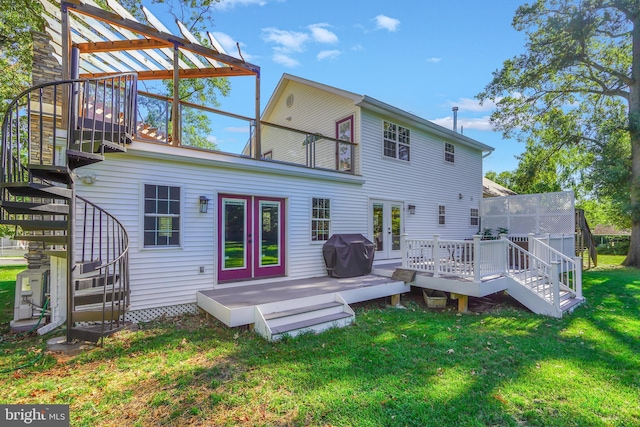 back of house with a lawn, a balcony, a deck, and french doors