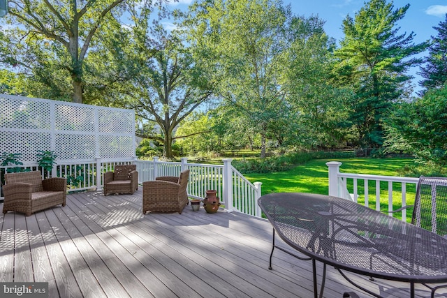 wooden deck featuring a yard