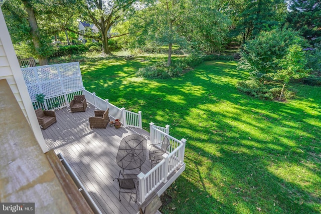 deck featuring outdoor lounge area and a yard