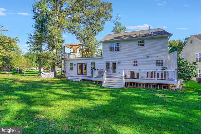 back of property featuring french doors, central air condition unit, a deck, and a lawn