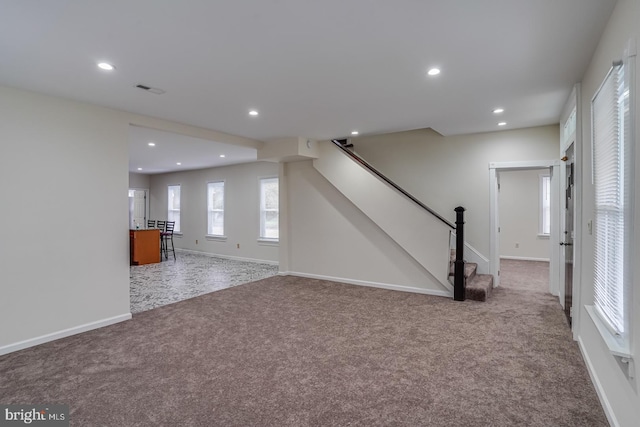 unfurnished living room featuring carpet floors