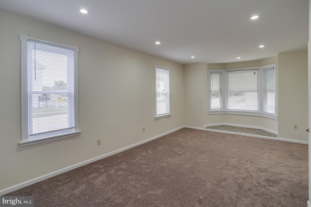 unfurnished room featuring carpet