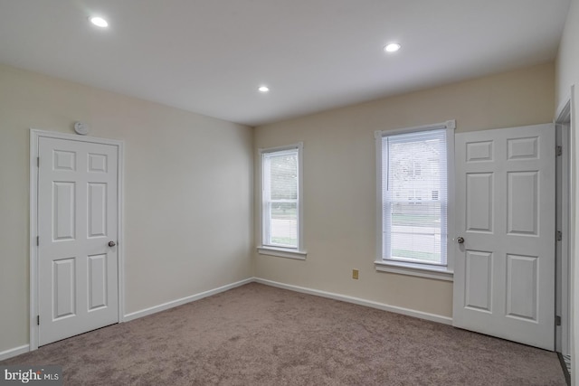 empty room featuring light carpet