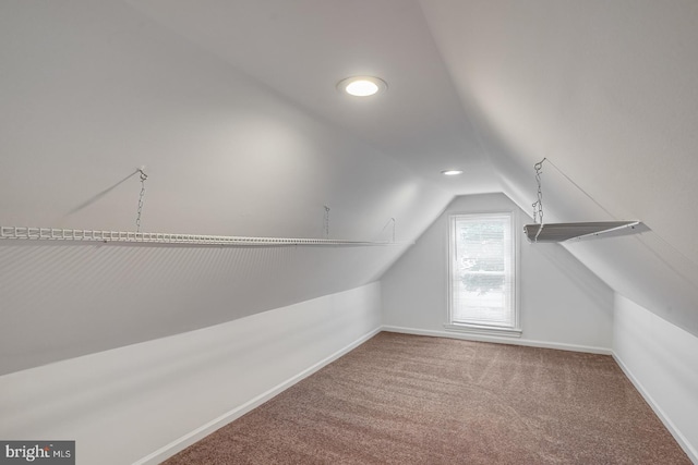 interior space featuring lofted ceiling and carpet flooring