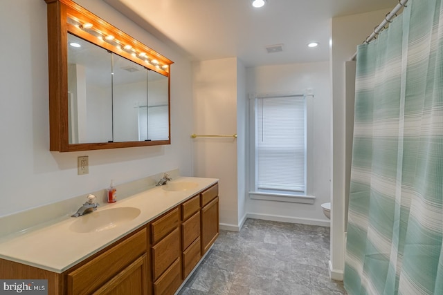 bathroom featuring vanity and toilet