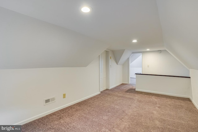 additional living space with lofted ceiling and light colored carpet