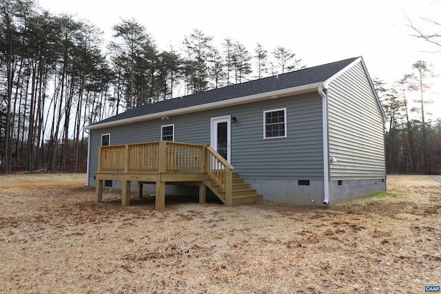 back of property featuring a wooden deck