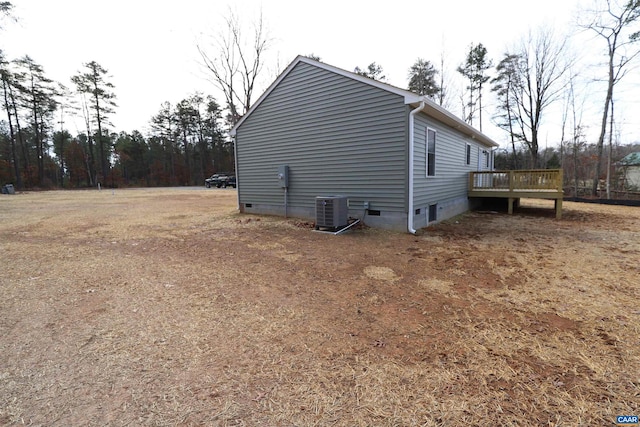 view of home's exterior with central AC and a deck