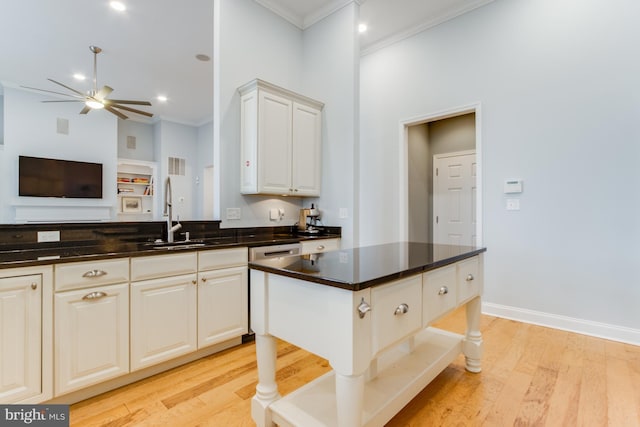 kitchen featuring white cabinetry, sink, ceiling fan, and light hardwood / wood-style floors