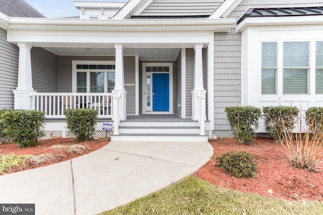 view of exterior entry featuring a porch