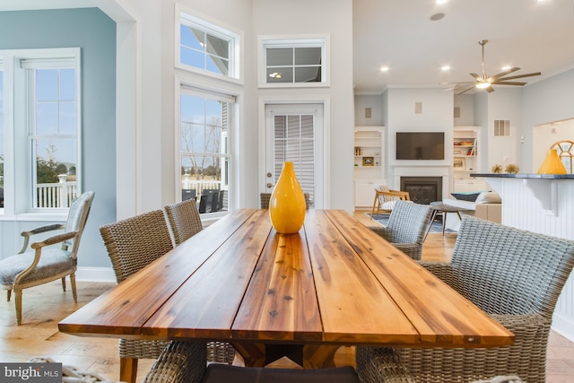 dining area with ceiling fan and built in features