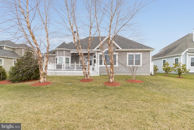 ranch-style home featuring a front lawn and covered porch