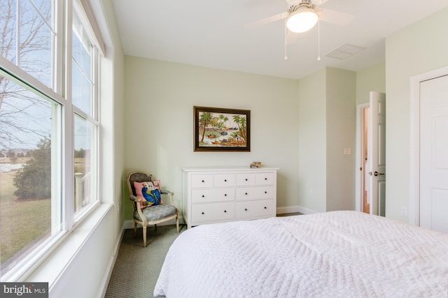 bedroom with carpet flooring, ceiling fan, and multiple windows