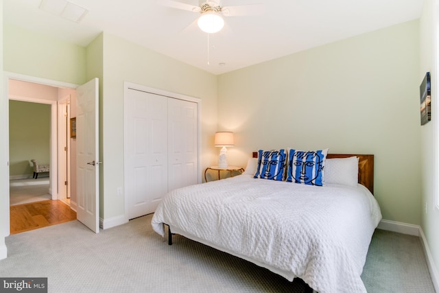 carpeted bedroom featuring ceiling fan and a closet