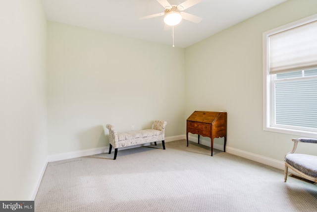 living area with ceiling fan and light colored carpet