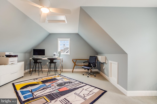 carpeted office space with vaulted ceiling