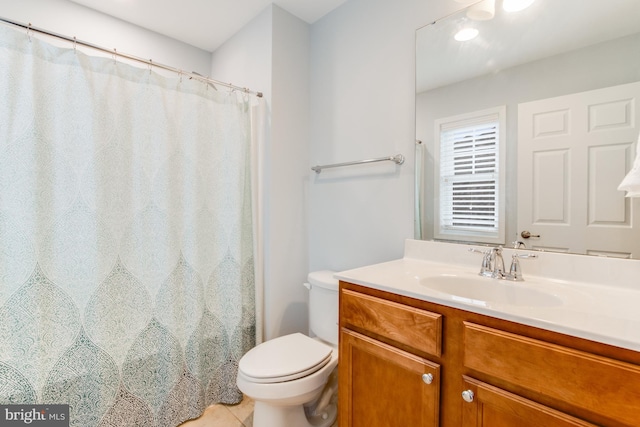 bathroom with tile patterned floors, vanity, and toilet