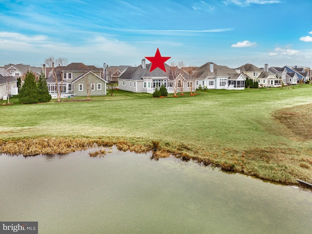 exterior space with a lawn and a water view