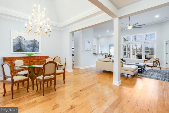 dining room with crown molding, a high ceiling, light hardwood / wood-style floors, and ceiling fan with notable chandelier