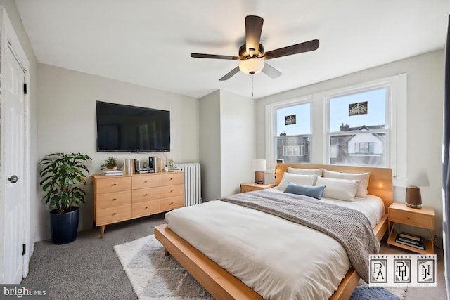 bedroom featuring radiator, ceiling fan, and dark colored carpet