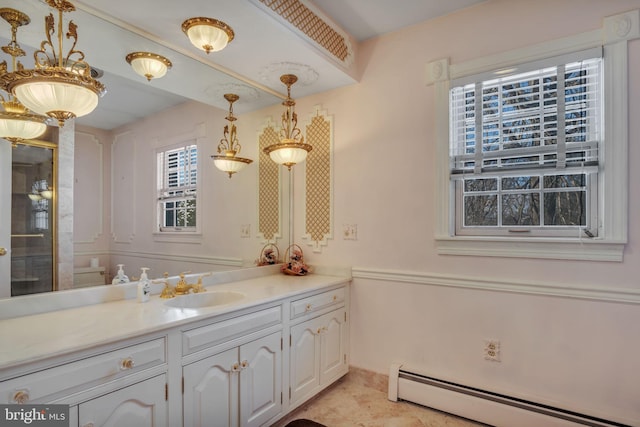 bathroom with vanity and a baseboard heating unit