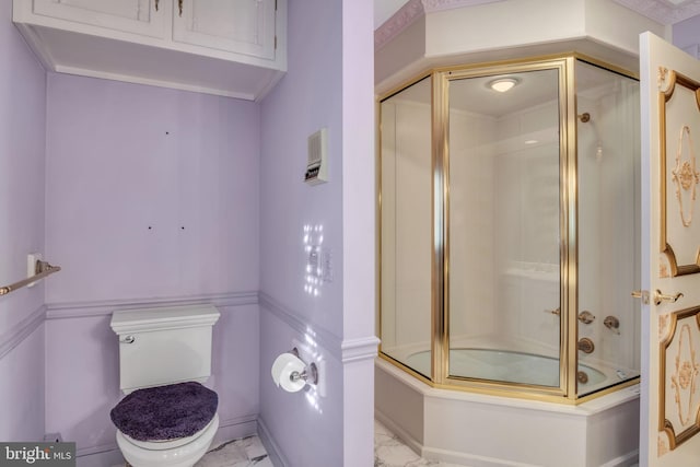 bathroom with enclosed tub / shower combo and toilet