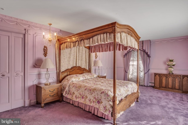 carpeted bedroom with a closet and a baseboard heating unit