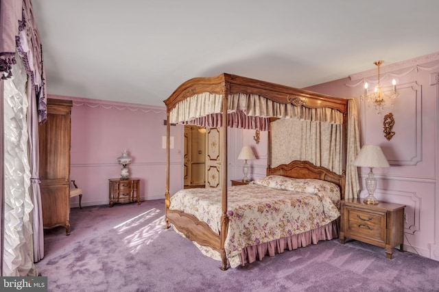 bedroom featuring carpet and an inviting chandelier